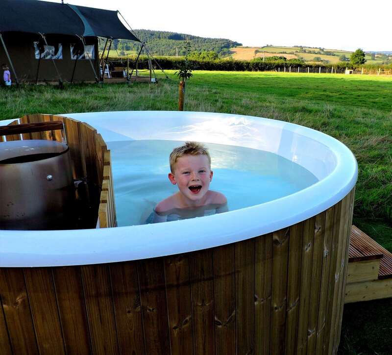 Glamping private hot tub by safari tent
